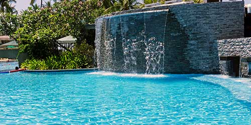 A gorgeous waterfall in a large custom swimming pool
