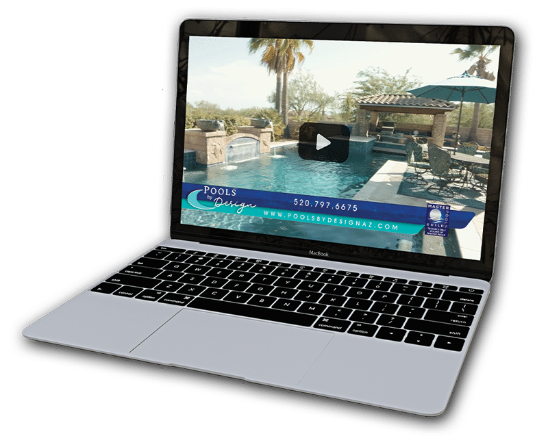 A laptop showing a Pools By Design video paused on the screen