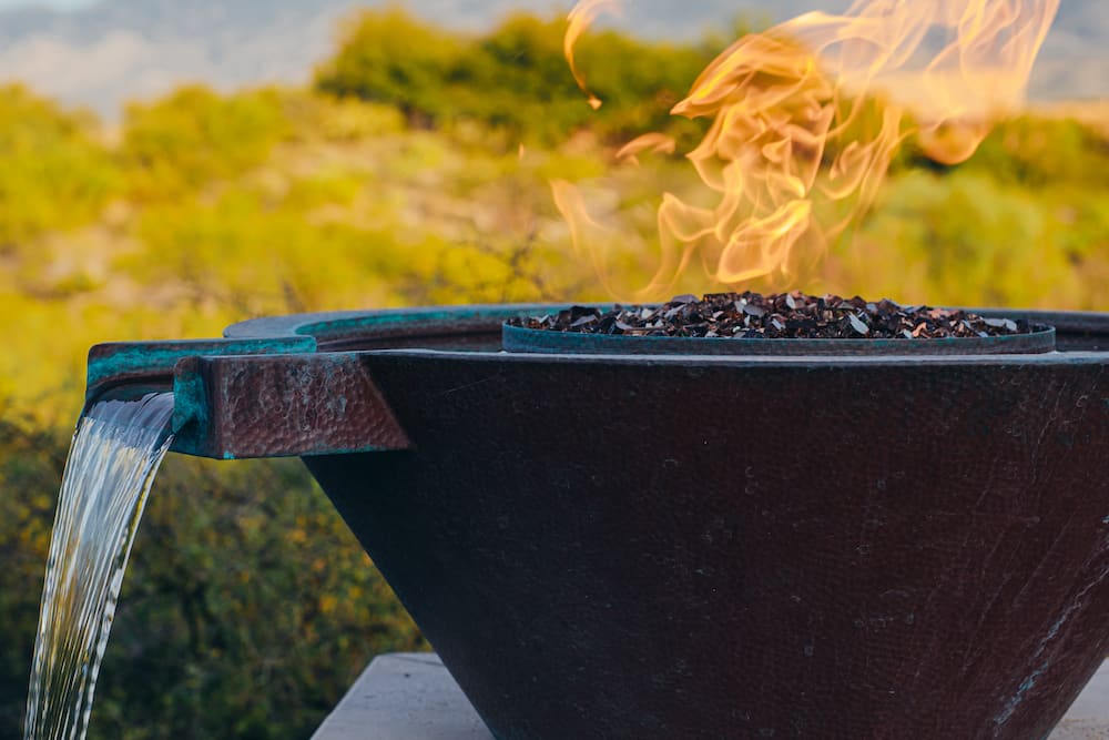 A metal fire bowl in a Tucson custom pool