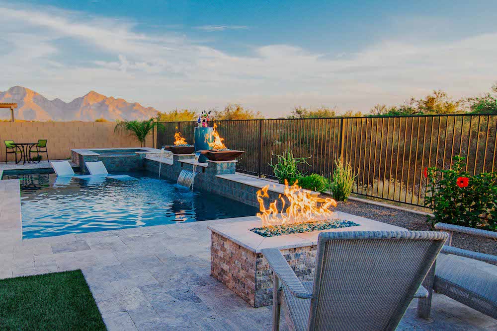 A beautiful custom pool in Tucson, AZ with fire features near the water and poolside