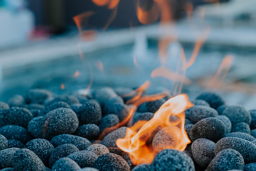 A close-up of lava stones in a pool fire feature