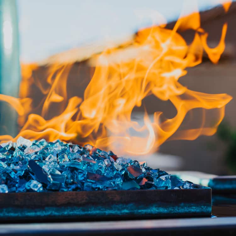 A close-up of a modern pool fire feature