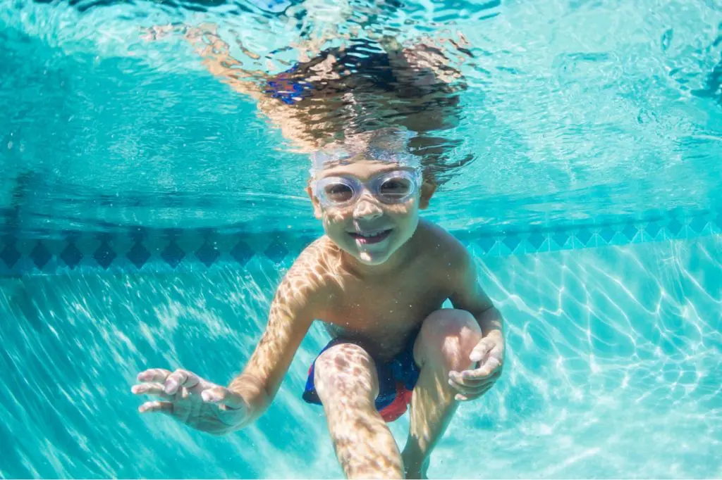 a boy with goggles in the pool