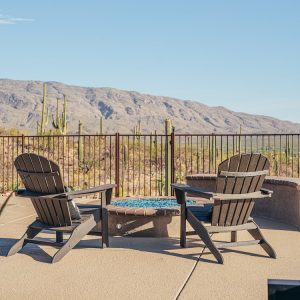 An outdoor living space with a fire pit with blue glass