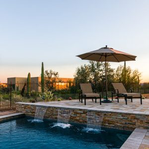 Poolside seating with water features on the ledge