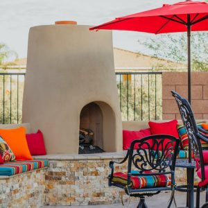 A Tucson poolside fire pit with vibrant cushions and a built-in seating area
