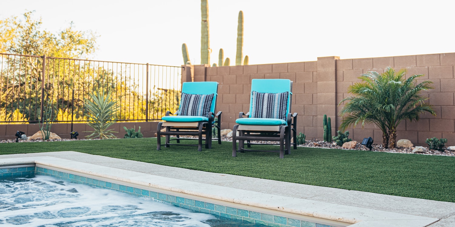 teal chairs near a bubbling hot tub built by pools by design