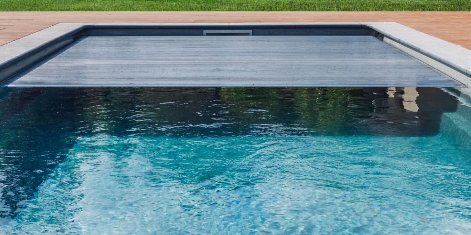 A pool cover over blue water