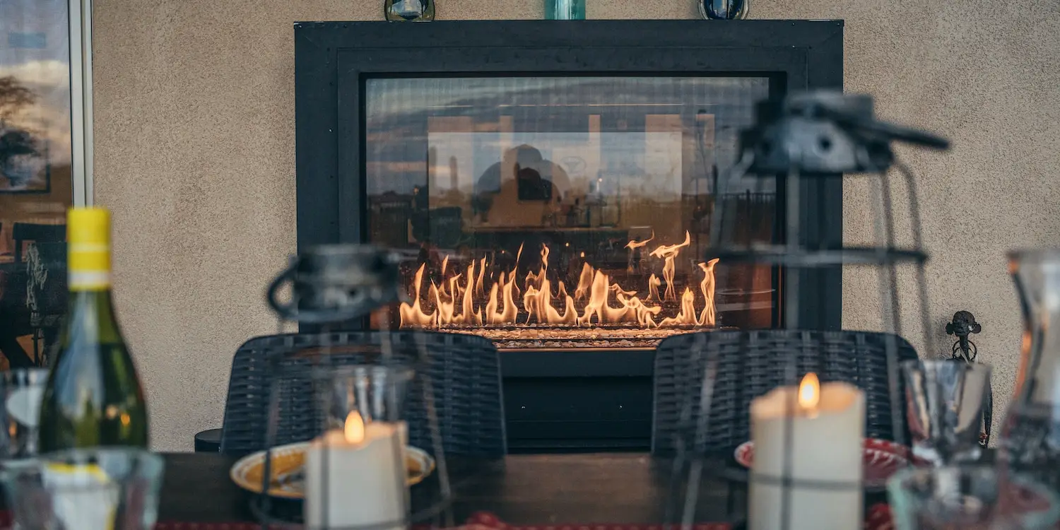 an outdoor living space with a fire pit and dining table